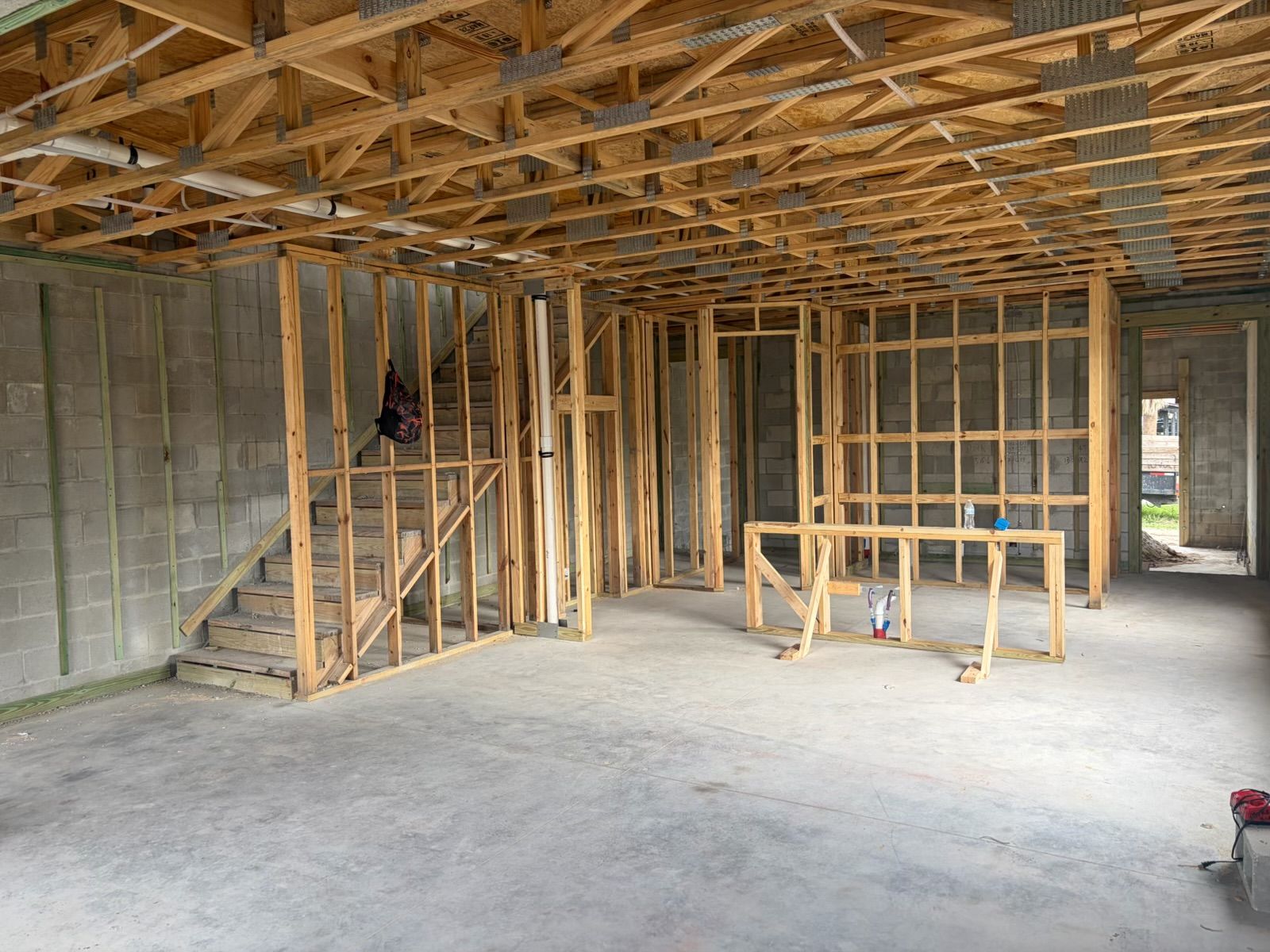 Construction progress: First floor: open living and kitchen area with interior walls framed